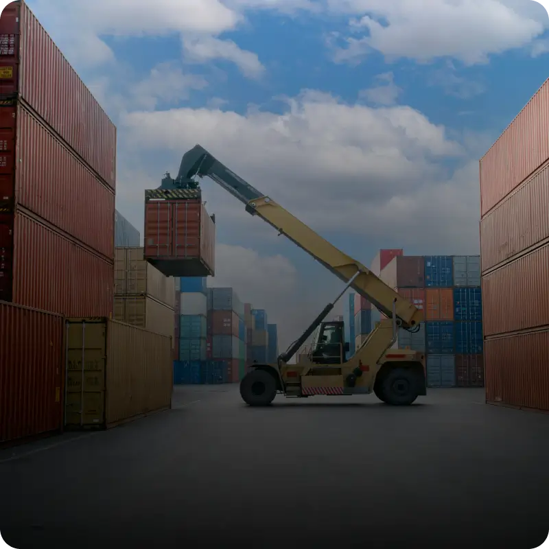 Cargo containers and forklift in storage yard