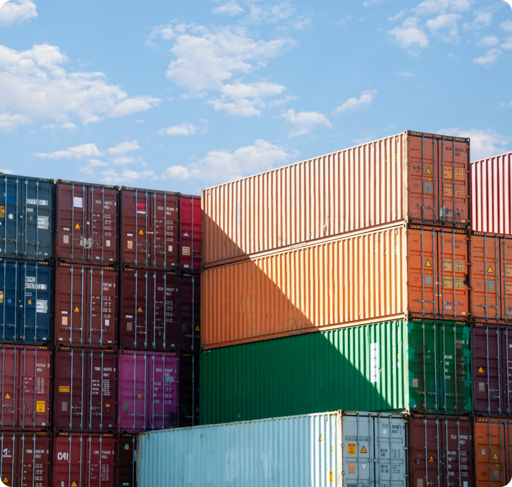 Multicolored cargo containers with clouded sky.