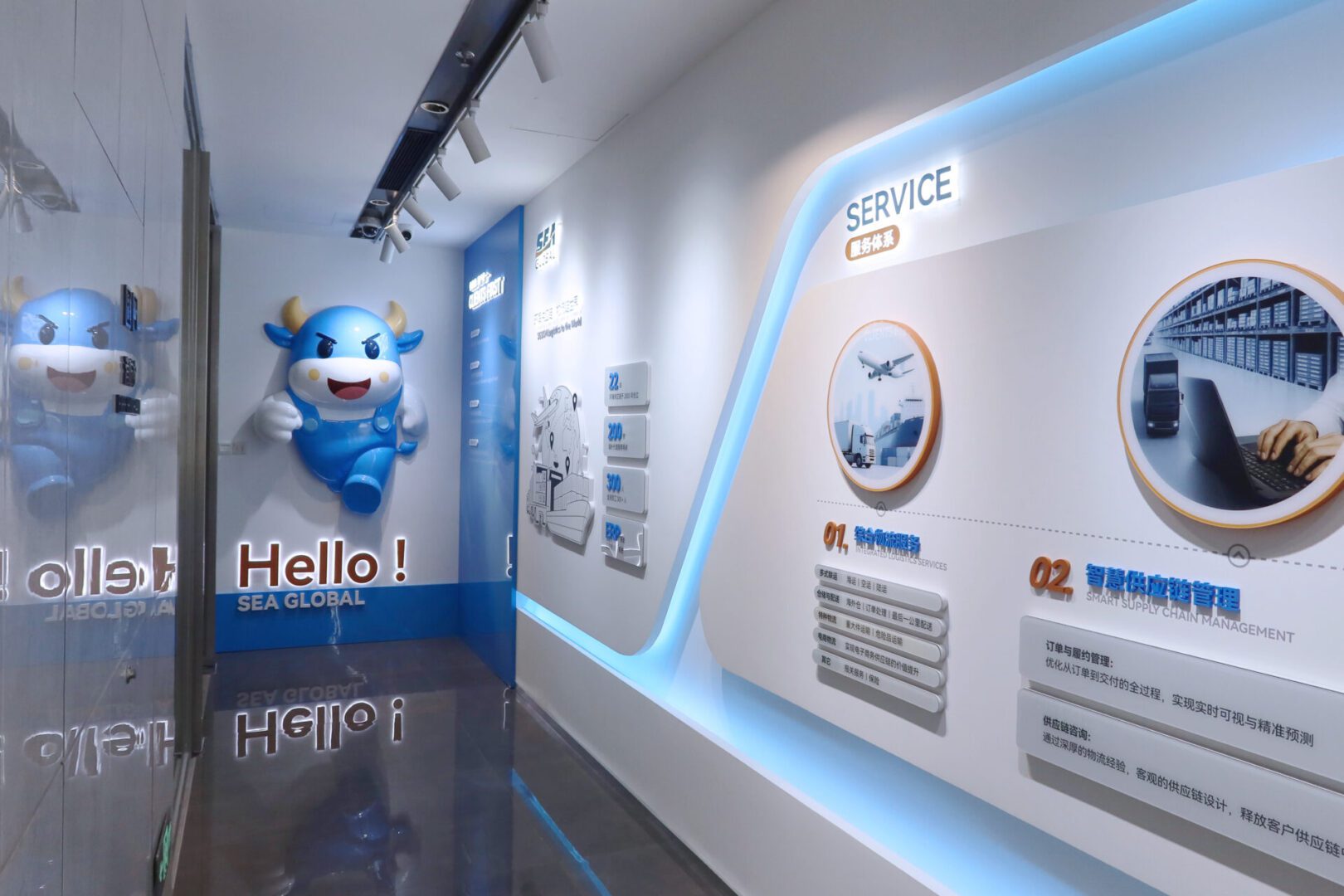 Robot mascot greets visitors in a modern, futuristic exhibit space.