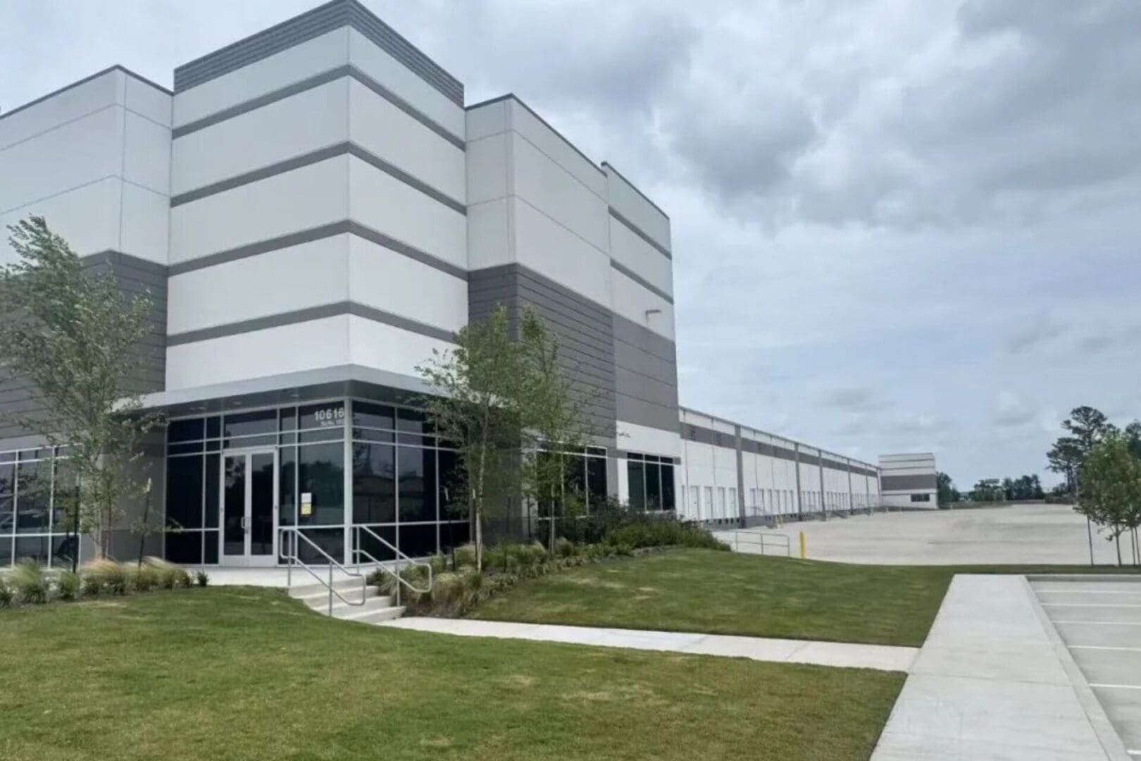 Modern warehouse building with empty parking lot